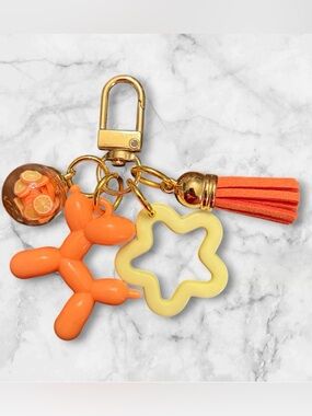 Playful Orange Balloon Dog Keychain with Yellow Star